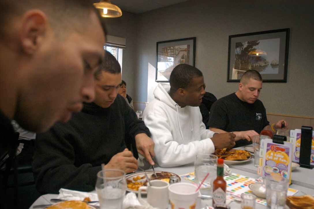 Sgt. William Colon, Cpl. Hamlet Tavarez, Lance Cpl. Ewell Thompson and Cpl. David Kusinitz dig in at Denny's before hitting the mountain.