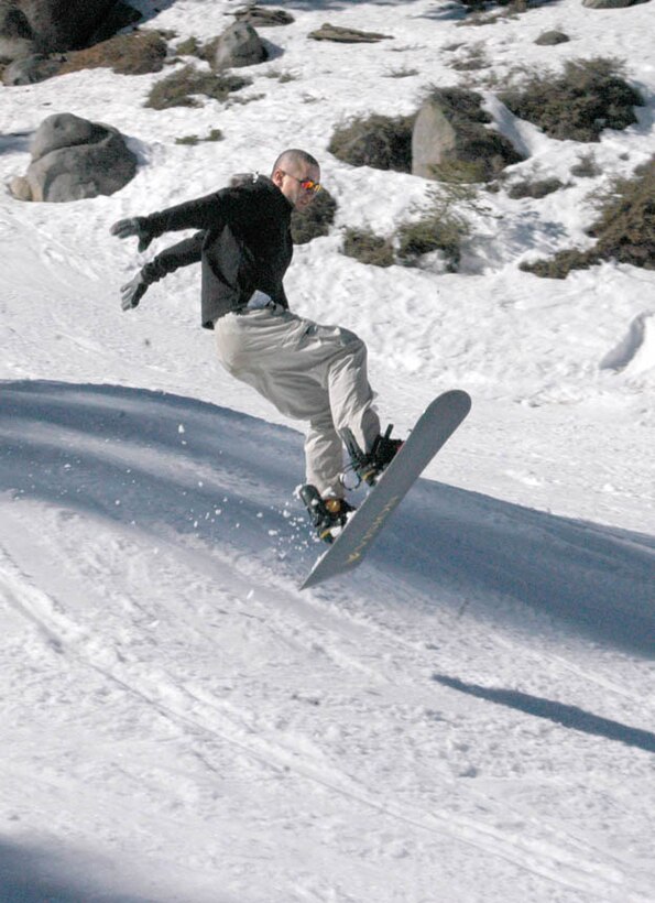 Pfc. Jonathan Jens, India Company 3rd Battalion 7th Marines automatic rifleman, looks for a mock sniper after a Marine was shot and injured during an assault training exercise as a part of the Weapons and Tactics Instructor course at the Trinity Christian Center, Yuma, Ariz., April 15.