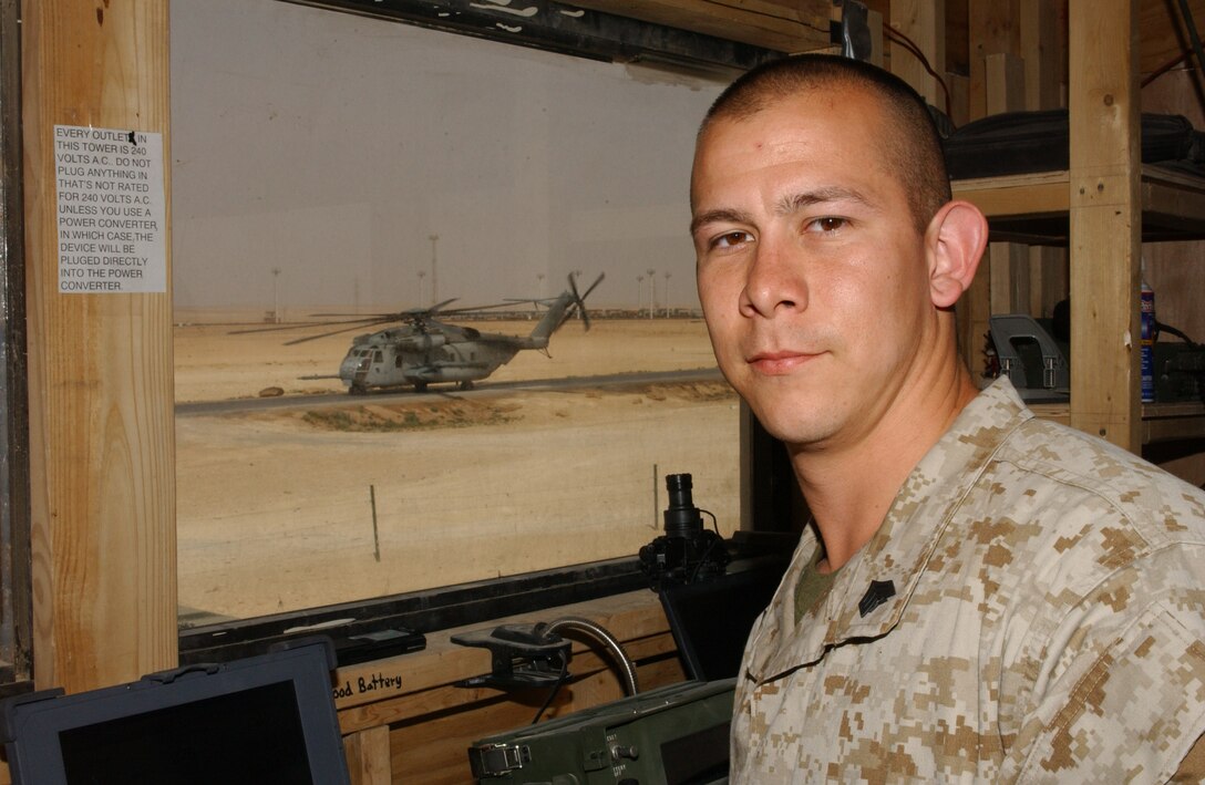 Sgt. Jacob M. Zamora, 23, Corpus Christi, Texas, air traffic controller, waits as a CH-53 Sea Knight helicopter sits on the landing strip.  This Marine is assigned to Marine Air Control Squadron 1, 2nd Marine Aircraft Wing, Al Qaim, Iraq.