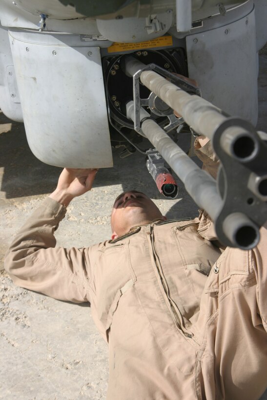 Sergeant Travis Storie, ordnance technician, Marine Light/Attack Helicopter Squadron 269, and Abington, Va., native checks a weapon system on one of the Gunrunners? AH-1W Super Cobras aboard Forward Operating Base Al Qaim, March 29.