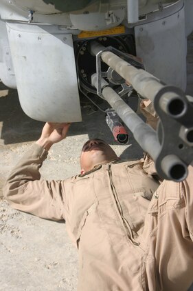 Sergeant Travis Storie, ordnance technician, Marine Light/Attack Helicopter Squadron 269, and Abington, Va., native checks a weapon system on one of the Gunrunners? AH-1W Super Cobras aboard Forward Operating Base Al Qaim, March 29.