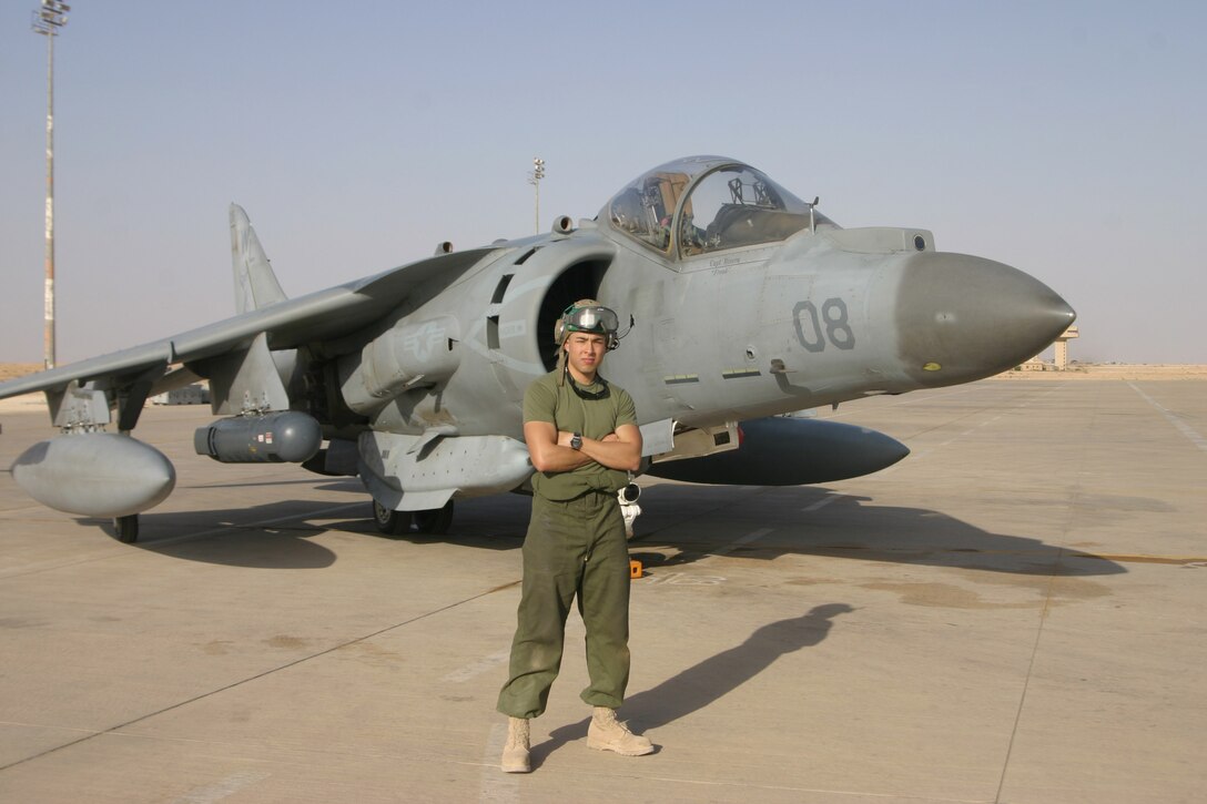 AL ASAD, Iraq - Sergeant Douglas Acero an avionics technician with Marine Attack Squadron 311 stands in front of an AV-8B Harrier here April 29. Acero along with his fellow ?Tomcats? of VMA-311 are scheduled to return to Marine Corps Air Station Yuma, Ariz., in May after a seven-month deployment in support of Operation Iraqi Freedom.