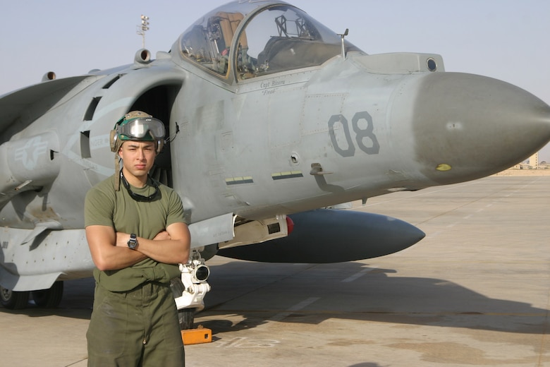 AL ASAD, Iraq - Sergeant Douglas Acero an avionics technician with Marine Attack Squadron 311 stands in front of an AV-8B Harrier here April 29. Acero along with his fellow ?Tomcats? of VMA-311 are scheduled to return to Marine Corps Air Station Yuma, Ariz., in May after a seven-month deployment in support of Operation Iraqi Freedom.