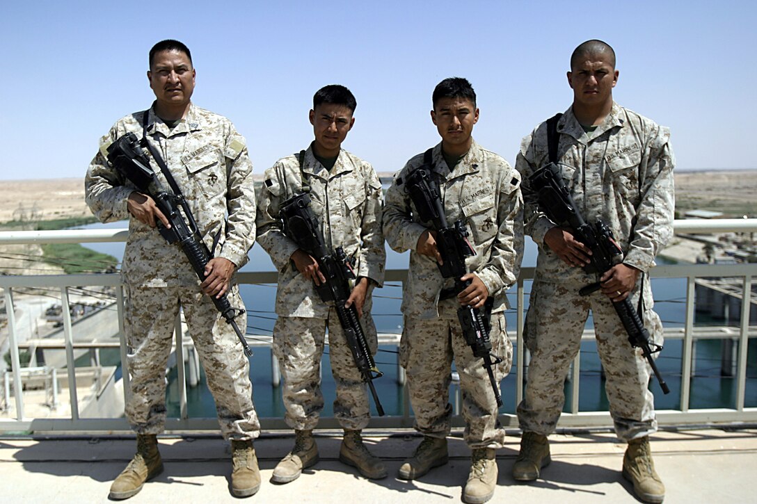 Al Asad, Al Anbar, Iraq  - Civil Affairs SNCOIC, Master Sgt. Steve Jakes, 46 of Tohlaki, N.M., Infantrymen Lance Cpl. Cheston E. Bailon,20 of Shiprock, N.M, Sgt. Leighton Redhouse, 25 of Upper Fruitland, N.M., Sgt. Jonathon D. Mc Kenzie, 27 of Shiprock, N.M., are all members of the Navajo Nation who are proudly serving thier country in Iraq with 3rd Battalion, 25th Marine Regiment.