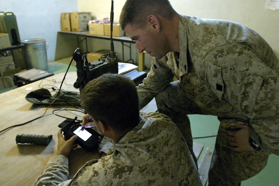 Haditha, Al Anbar, Iraq (June 10, 2005) -Strongsville, Ohio native, Sgt.Daniel J. Byrnes,27, a radio watch supervisor with 3/25 helps out another student in the practical application section of the course. (Official USMC photo by Cpl. Ken Melton)