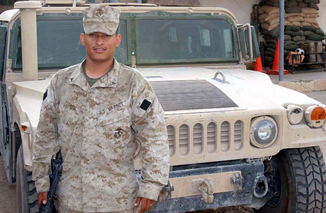 CAMP FALLUJAH, Iraq -- Lance Cpl. Juan M. Flores, a mortarman with Weapons Company, 3rd Battalion, 8th Marine Regiment uses his language skills learned in the Survival Language Arabic Course he took while preparing for deployment to Operation Iraqi Freedom to speak with locals during vehicle checkpoints and random house searches.  Official U.S. Marine Corps photo by Lance Cpl. Athanasios L. Genos