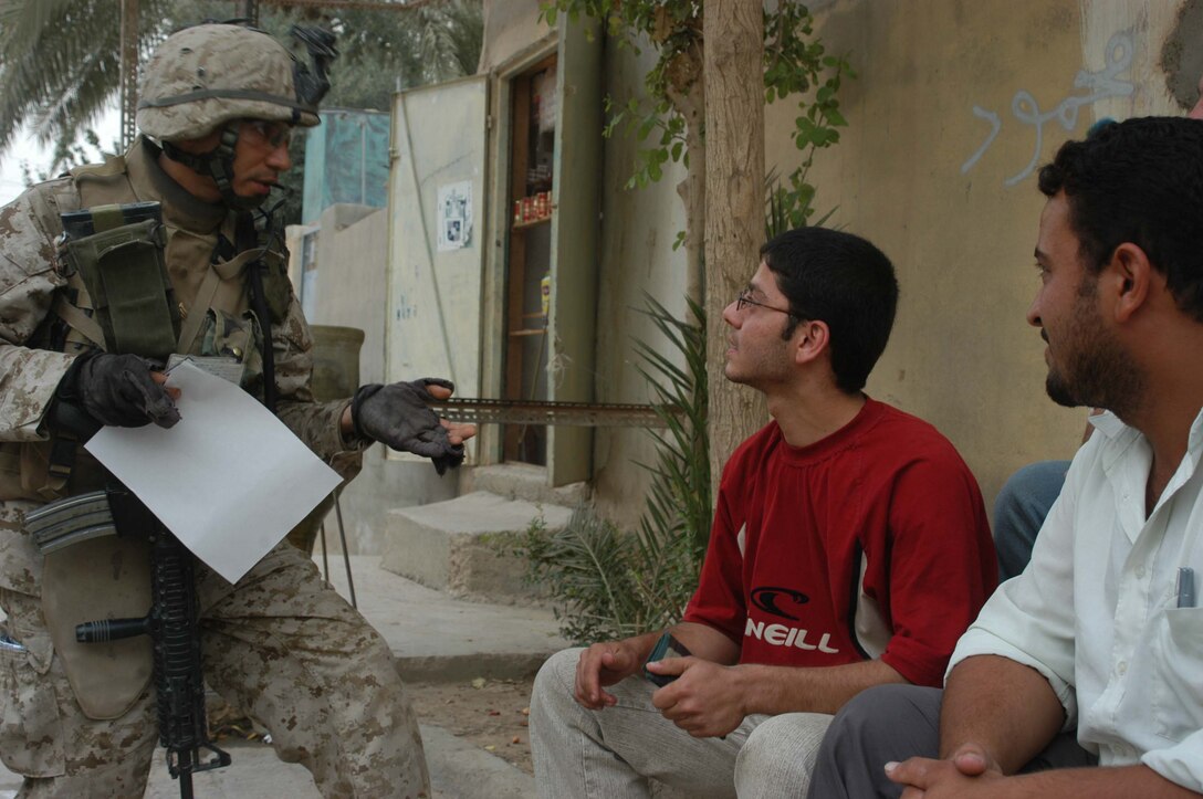 AR RAMADI Iraq (June 29, 2005)-Sergeant Joe A. Salinas, squad leader for 3rd Squad, 4th Platoon, Company B, 1st Battalion, 5th Marine Regiment, questions an Iraqi man if he knows about any insurgent activity during a mission in the city here June 28. The 35-year-old from San Antonio, Texas and his fellow Marines conducted a patrol through a portion of their company's area of operations to locate enemy sniper positions. Company B's observation post has been taking sporadic sniper fire from the area around it. Photo by: Cpl. Tom Sloan