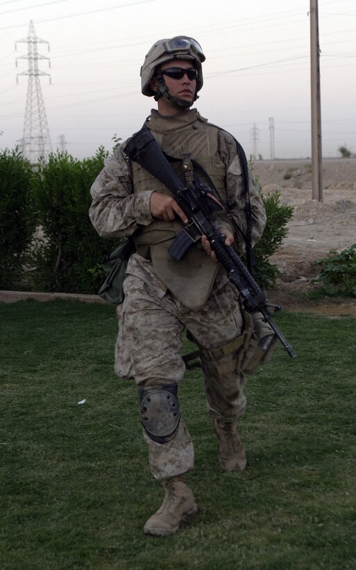SAQLAWIYAH, Iraq - Lance Cpl. Howard Aycock, a machine gunner with 2nd Platoon, Company A, 1st Battalion, 6th Marine Regiment, patrols the streets of a village outside Saqlawiyah codenamed 'Shadyville' June 29.  The 26-year-old Sarasota, Fla. native's unit assisted the Iraqi Security Forces during 'Operation Shadyville,' a mission that netted several suspected insurgent supporters, two improvised explosive devices, and 50 AK-47 assault rifles.