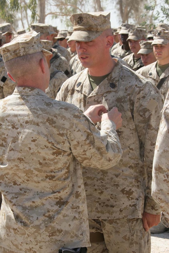 CAMP FALLUJAH, Iraq -- Major General Richard A. Huck, 2nd Marine Division Commanding General visited 3rd Battalion, 8th Marine Regiment  presented Gunnery Sgt. Brendan Slattery with his Purple Heart.  Huck also spoke to the Marines about the job they have been doing so far.  Official U.S. Marine Corps photo by Lance Cpl. Athanasios L. Genos