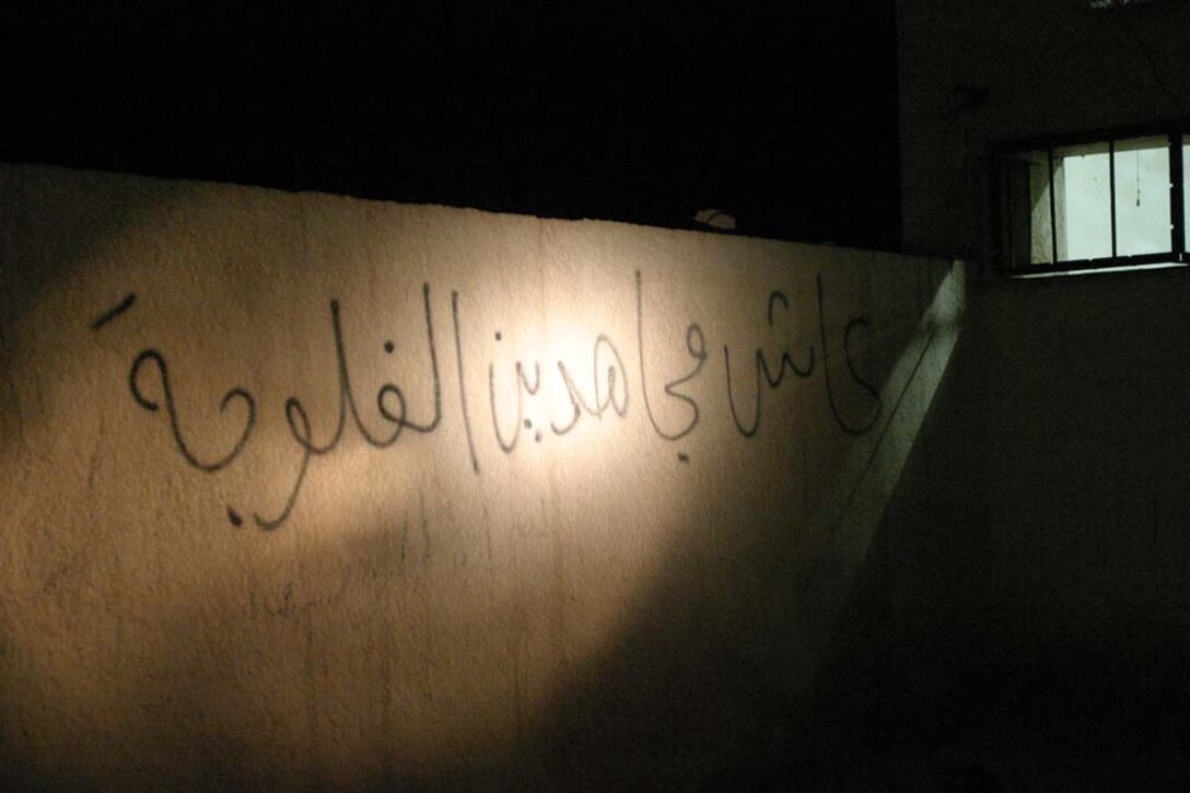HIT, Iraq- (June 28, 2005) A wall depicts anti-coalition graffitti "Long live the mujahideen in Fallujah" where Marines with 3rd Battalion, 25th Marine Regiment, Company L search for weapons during Operation Sword.  The operation was conducted to destroy insurgency leadership strong points.  The Marines of 2nd Marine Division conducted counter-insurgency operations with Iraqi Security Forces to isolate and neutralize anti-coalition forces.  U.S. Marine Corps photo Cpl. Eric C. Ely (RELEASED)