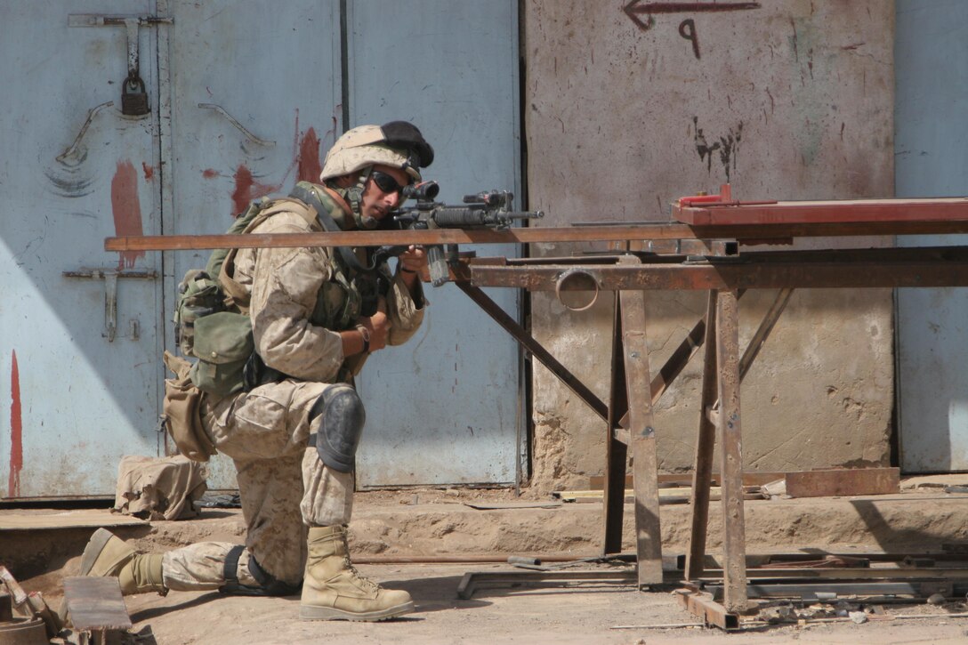 HIT, Iraq (June 30, 2005)- A Marine with 3rd Battalion, 25th Marine Regiment, Regimental Combat Team-2 sets up security during a patrol in the city during Operation Guardian Sword conducted to clear the city and set-up Iraqi Security Forces firm bases through out the city. The Marines of 2d Marine Division conduct counter-insurgency operations with Iraqi Security Forces to isolate and neutralize anti-Iraqi forces, to support the continued development of Iraqi Security Forces, and to support Iraqi reconstruction and democratic elections in order to create a secure environment that enables Iraqi self-reliance and self-governance. (Official USMC photo by Lance Cpl. Lucian Friel )(RELEASED)