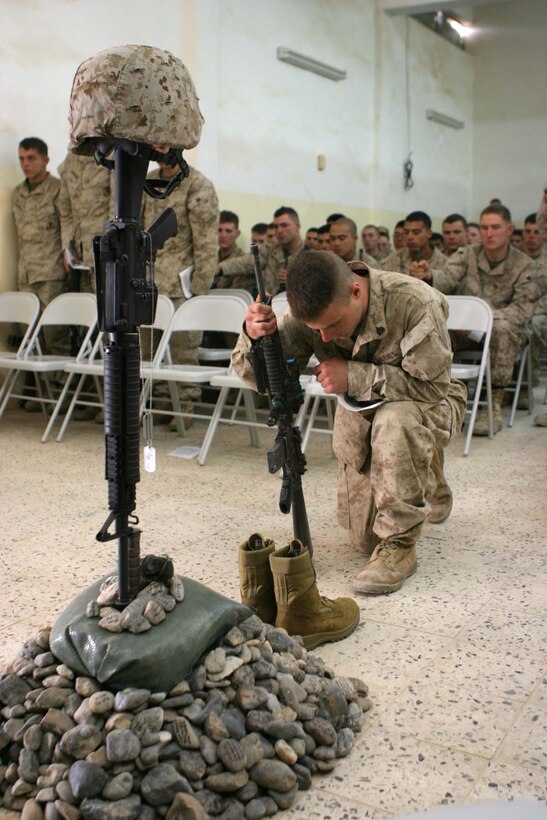 HADITHA, Iraq (Nov. 29, 2005)  - A Marine with Kilo Company, 3rd Battalion, 1st Marine Regiment pays final respects to Lance Cpl. Miguel Terrazas during memorial service here Nov. 29. Terrazas, an El Paso, Texas native and rifleman with the Kilo Company became the first Marine lost in that company since arriving here in September. (Official Marine Corps photo by Cpl. Adam C. Schnell)