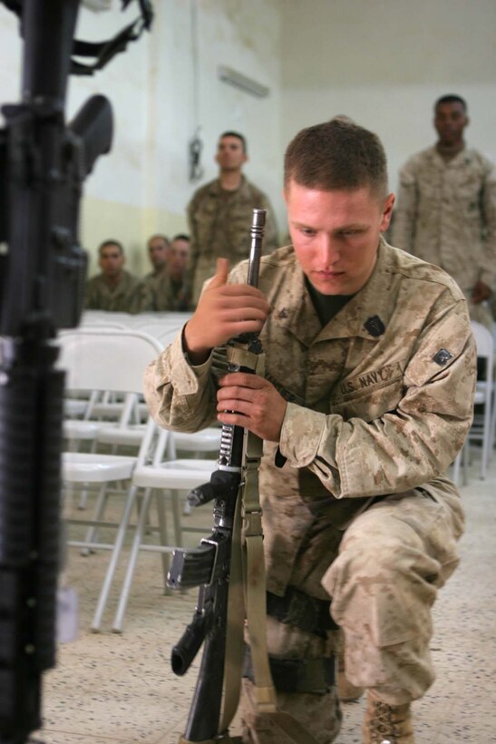 HADITHA, Iraq (Nov. 29, 2005)  - A Navy Corpsman with Kilo Company, 3rd Battalion, 1st Marine Regiment pays final respects to Lance Cpl. Miguel Terrazas during memorial service here Nov. 29. Terrazas, an El Paso, Texas native, served bravely as a rifleman with Kilo Company for many months before an improvised explosive device struck his vehicle and took his life. (Official Marine Corps photo by Cpl. Adam C. Schnell)