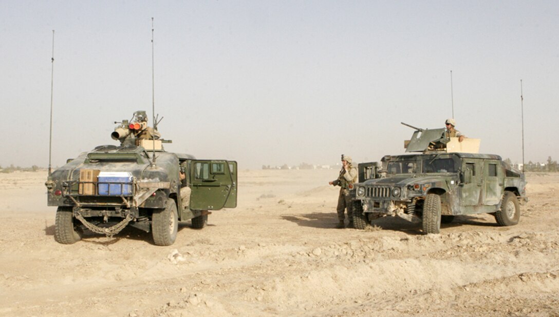 Iraqi poll workers are searched by Marines with Bravo Company, 1st Battalion, 5th Marine Regiment, with metal detectors, Jan. 29, 2005, in Baghdadi, Iraq, outside one of Iraq's nearly 5,200 polling stations waiting to be searched by U.S. Marines before entering the site. As soldiers from the Iraqi Army provided security within the polling site, infantrymen with the 1st Battalion, 3rd Marine Regiment kept vigilant eyes from surrounding rooftops for any signs of intimidation or violence. The election will create a 275-member National Assembly and 18 provincial legislatures. The newly elected assembly will draw up the country's permanent constitution and select a president and two deputy presidents, who will name a new prime minister and Cabinet to serve for 11 months until new elections are held.