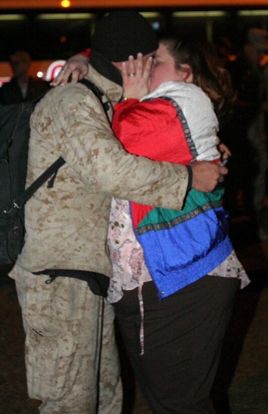 MARINE CORPS BASE CAMP LEJEUNE, N.C. - A Marine with 1st Battalion, 8th Marine Regiment kisses a family member for the first time in seven months after returning from Iraq Jan. 28. The battalion participated in the battles in Fallujah and captured massive amounts of weapons and ammunition.