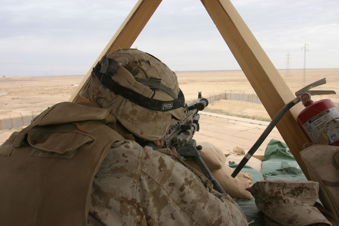 CAMP AL QA'IM, Iraq (April 6, 2005)- Lance Cpl. Jeffery Quattlebaum, a team leader with 2nd Platoon, K Company, 3rd Battalion, 2nd Marine Regiment, Regimental Combat Team 2 scans the local area during his over watch post here April 6. The Philadelphia native has a tremendous responsibility of guarding Camp Al Qa'im and maintaining security of their forward operating base. Official U.S. Marine Corps photo by Lance Cpl. Lucian Friel (RELEASED)