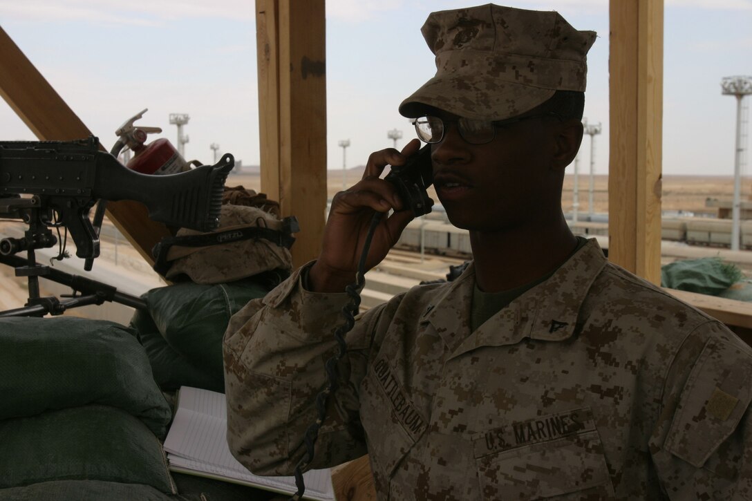 CAMP AL QA'IM, Iraq (April 6, 2005)- Lance Cpl. Jeffery Quattlebaum, a team leader with 2nd Platoon, K Company, 3rd Battalion, 2nd Marine Regiment, Regimental Combat Team 2 calls in a radio check before his over watch post here April 6. The Philadelphia native and 2002 University City High School graduate has a tremendous responsibility of guarding Camp Al Qa'im and maintaining security of their forward operating base. Official U.S. Marine Corps photo by Lance Cpl. Lucian Friel (RELEASED)