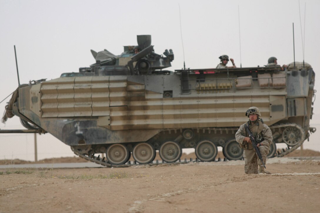 CAMP RIPPER, AL ASAD, Iraq -- Lance Cpl. Matthew Snyder, a 20-year-old Tampa, Fla. native and rifleman with Beowulf, takes up a security position near an Amphibious Armored Vehicle for a cordon and knock mission, April 15.  The 2003 Bloomingdale High School graduate is attached to Beowulf, the regimental reserve force for Regimental Combat Team 2, responsible for a myriad of tasks from security and sustainment operations to setting up snap vehicle control points.  U.S. Marine Corps photo by Sgt. Stephen D'Alessio (RELEASED)