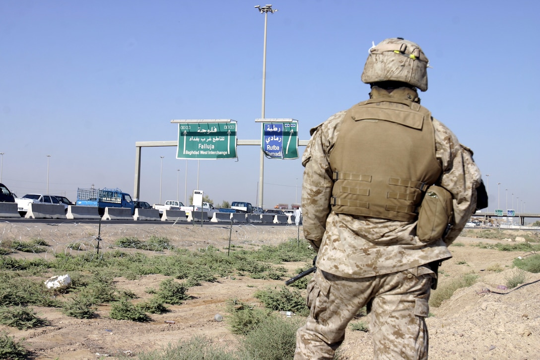 FALLUJAH, Iraq - A Marine with 1st Combined Anti-Armor Team, Weapons Company, 1st Battalion, 6th Marine Regiment provides security along a military avenue leading into Fallujah Aug. 30.  Marines from the battalion's four CAAT platoons routinely patrol the city's streets and alleyways aboard their armored trucks and on foot to search for insurgent activity and improvised explosive devices.