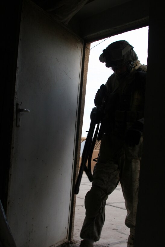 AR RAMADI, Iraq (November 30, 2005) - A Marine with Combined Anti-Armor Team White, 3rd Battalion, 7th Marine Regiment, comes in from the roof a cleared building during Taskforce Block Party Six Nov. 30. Photo by Cpl. Shane Suzuki