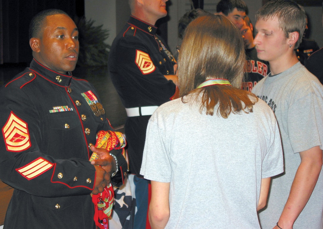 Gunnery Sgt. Lonnelle V. Jones speaks to students of Attica High School about the Marine Corps after participating in a Veterans' Day ceremony at the school in Attica, Ind.,  Nov. 11. In addition to speaking to students, recruiters are now spending much more time with parents. Parents have much more influence over their childrens decisions today, and their concerns over world operations are becoming a big part of the recruiters' jobs. (Official U.S. Marine Corps photo by Sgt. Jason D. Gallentine)