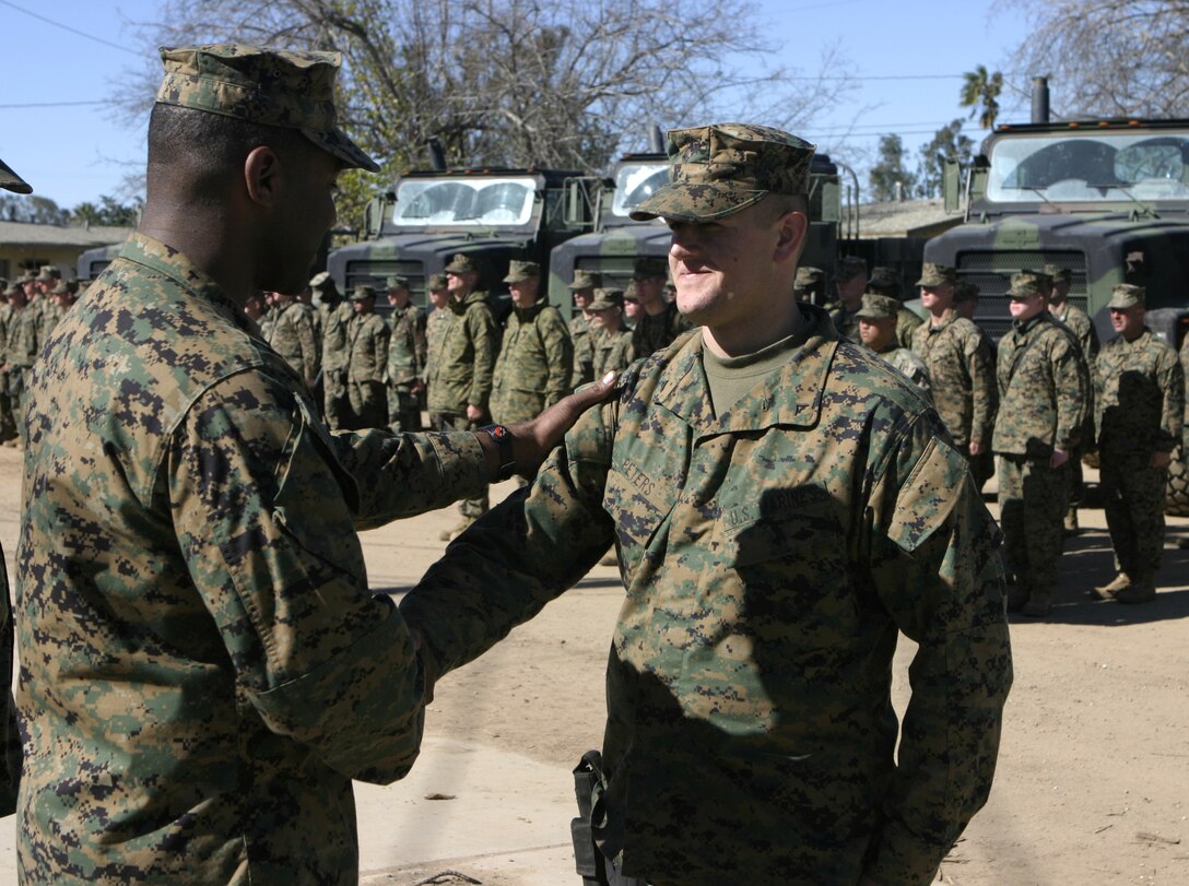 MARCH AIR RESERVE BASE, Calif. - Standing in front of a formation here, Lance Cpl. David E. Peters, Headquarters and Service Company, 1st Battalion, 6th Marine Regiment armory custodian, reenlists in the Marine Corps.  The Orient, Ohio native has served approximately three and a half years as an infantryman and will soon deploy with his unit in support of Operation Iraqi freedom.