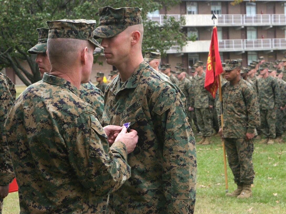 MARINE CORPS BASE CAMP LEJEUNE, N.C. - Lance Cpl. Brandon Wells, a tank crewman with Company B, 2nd Tank Battalion, 2nd Marine Division, is presented his Purple Heart Medal here Oct. 31.  The 20-year-old Murray, Ky. native and fellow Marine, Sgt. Brent Sheets, were both awarded this medal for injuries sustained after a roadside bomb detonated near their vehicle while they had been conducting security and stability operations in Iraq's Al Anbar province May 1.