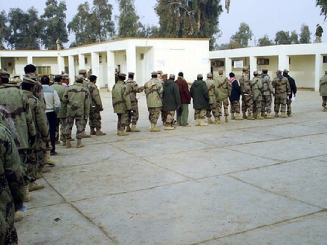Iraqi Army troops line up to cast their votes at a polling site in the Al Monsour district of Baghdad during Iraq's first free national election in over 50 years on Jan. 30, 2005. Millions of Iraqi's throughout the country are participating in this historic event. 