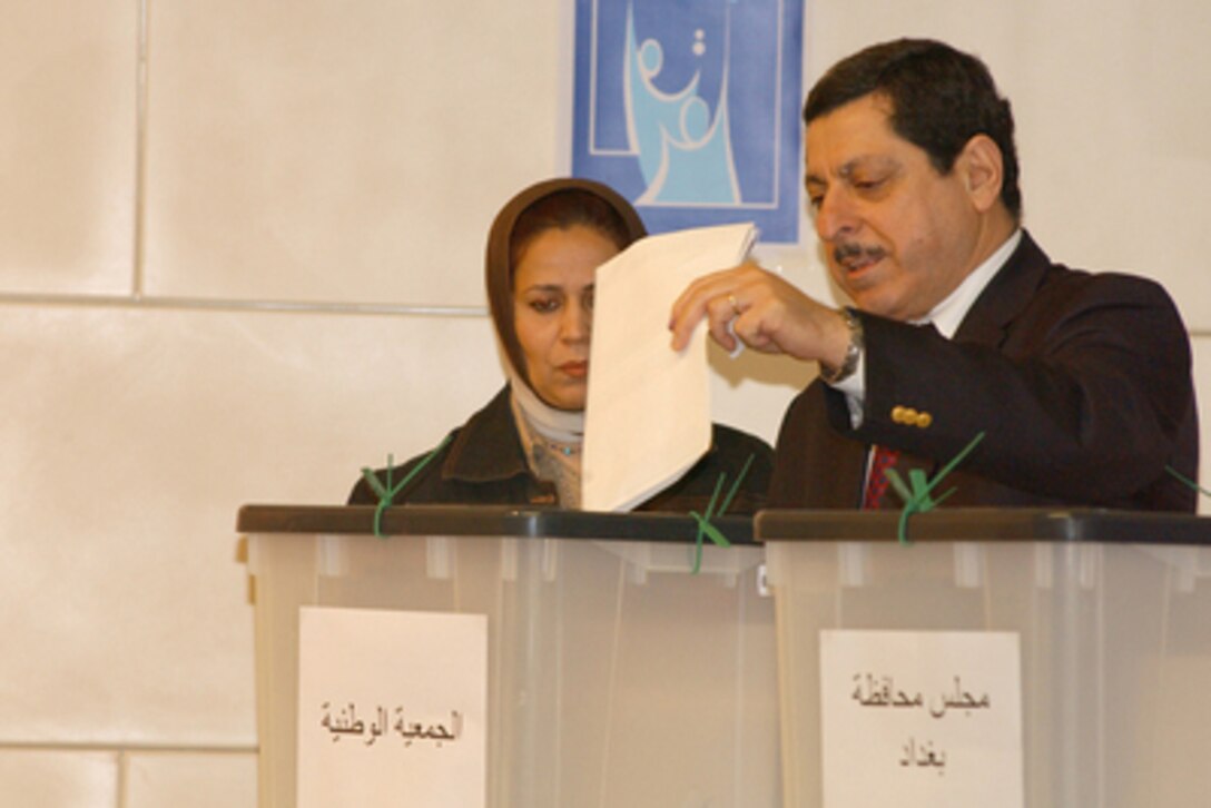Iraqi Spokesman for the Independent Electoral Commission Iraq Farid Ayar casts his ballot in Iraq's first free election at a polling station in the Baghdad Convention Center in Baghdad, Iraq, on Jan. 30, 2005. Millions of Iraqis throughout the country are participating in Iraq's first free election in over 50 years. 