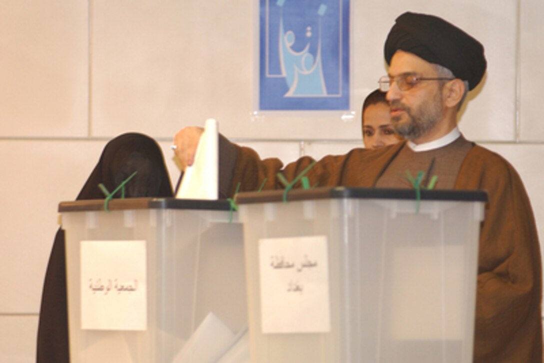 Abdul Aziz al-Hakim, the leader of the Supreme Council for the Islamic Revolution in Iraq party, casts his ballot in Iraq's first free election at a polling station in the Baghdad Convention Center in Baghdad, Iraq, on Jan. 30, 2005. Millions of Iraqis throughout the country are participating in Iraq's first free election in over 50 years. 
