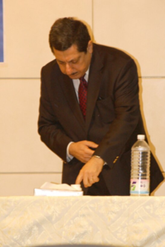 Iraqi Spokesman for the Independent Electoral Commission Iraq Farid Ayar dips his finger into a jar of indelible ink as he prepares to cast his ballot in Iraq's first free election at a polling station in the Baghdad Convention Center in Baghdad, Iraq, on Jan. 30, 2005. Everyone voting in the historic election has to mark their finger with the ink to indicate they have already voted as a means to deter voting fraud. Millions of Iraqis throughout the country are participating in Iraq's first free election in over 50 years. 