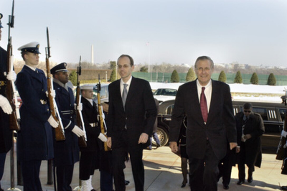 Secretary of Defense Donald H. Rumsfeld (right) escorts Luxembourg's Minister of Defense Luc Frieden (left) into the Pentagon on Jan. 31, 2005. The two leaders will meet to discuss defense issues of mutual interest. 