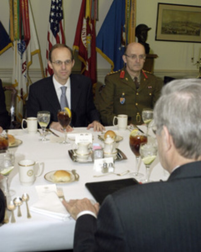 Secretary of Defense Donald H. Rumsfeld (foreground) meets with Luxembourg's Minister of Defense Luc Frieden (left) and the Chief of Staff of the Luxembourg Army Col. Nico Ries in the Pentagon on Jan. 31, 2005. Rumsfeld, Frieden and their senior staff are meeting to discuss defense issues of mutual interest. 