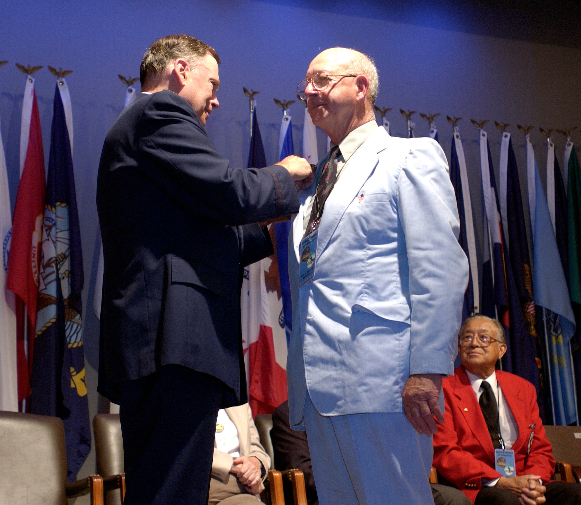 WASHINGTON -- Air Force Chief Of Staff Gen. John P. Jumper pins the World War II Honorable Service Lapel Pin on Staff Sgt. Chester Buck June 30 during a reception for World War II veterans, active duty members, family and friends which followed a wreath laying ceremony at Arlington National Cemetery's Tomb of the Unknowns.  The ceremony commemorated airpower and the 60th anniversary of World War II.  The lapel pin, known as the Ruptured Duck because of its design, depicts an eagle inside a wreath.  It was issued to service men and women who were about to leave the military with an honorable discharge.  Sergeant Buck served as a crew chief during World War II.  (U.S. Air Force photo by Master Sgt. Jim Varhegyi)