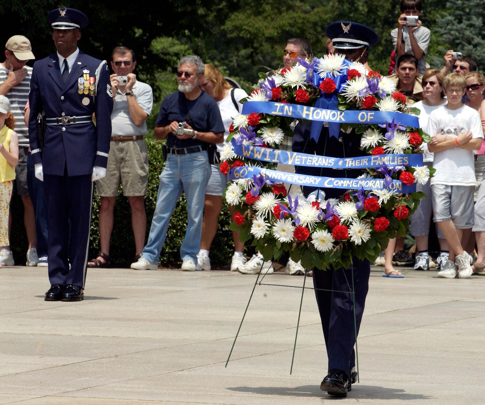 WASHINGTON -- A member of the U.S. Air Force Honor Guard bears a wreath which Air Force Chief of Staff Gen. John P. Jumper, Ms. Toby Felker and retired Air Force Lt. Col. William Czabaranek placed at Arlington National Cemetery's Tomb of the Unknowns June 30 during a ceremony commemorating airpower and the 60th anniversary of World War II.  (U.S. Air Force photo by Master Sgt. Jim Varhegyi)