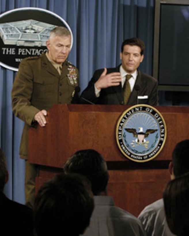 Principal Deputy Assistant Secretary of Defense for Public Affairs Lawrence Di Rita (right) responds to a reporter's question during a Pentagon press briefing on June 30, 2005. Di Rita and Joint Staff Director for Operations Lt. Gen. James T. Conway, U.S. Marine Corps, (left) conducted the briefing. 
