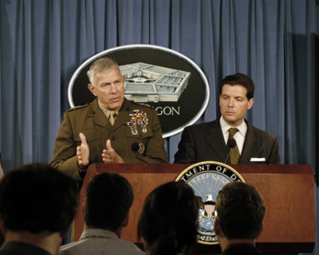 Joint Staff Director for Operations Lt. Gen. James T. Conway (left), U.S. Marine Corps, responds to a reporter's question during a Pentagon press briefing on June 30, 2005. Conway and Principal Deputy Assistant Secretary of Defense for Public Affairs Lawrence Di Rita (right) conducted the briefing. 