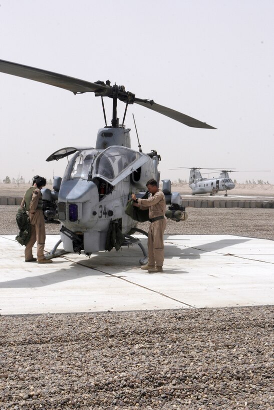 AL ASAD, Iraq ? Cpl. Robert E. Johnson, ground support equipment mechanic and electrician originally from Baltimore, adjusts a compressor valve in a mobile air conditioner July 1.  The mobile air conditioner is used to cool the inside of aircraft, primarily KC-130Js, so that technicians can work on the avionics components.