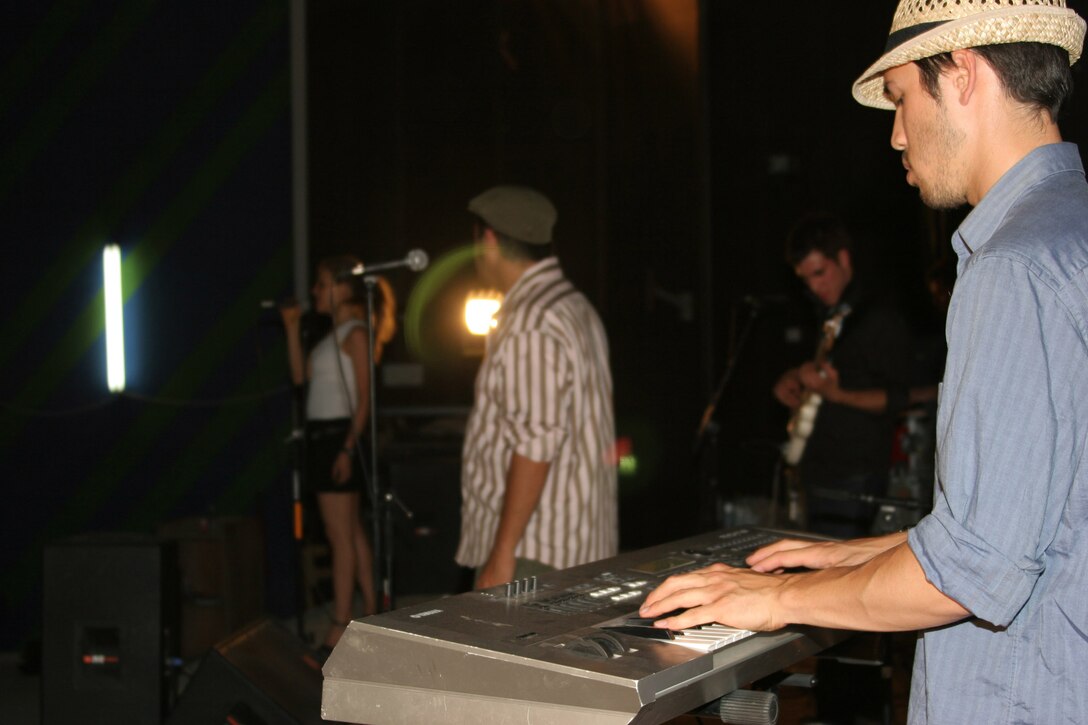 AL ASAD, Iraq ? Keyboard player with Insoul Jeff Goodkind plays during the bands performance here July 3.