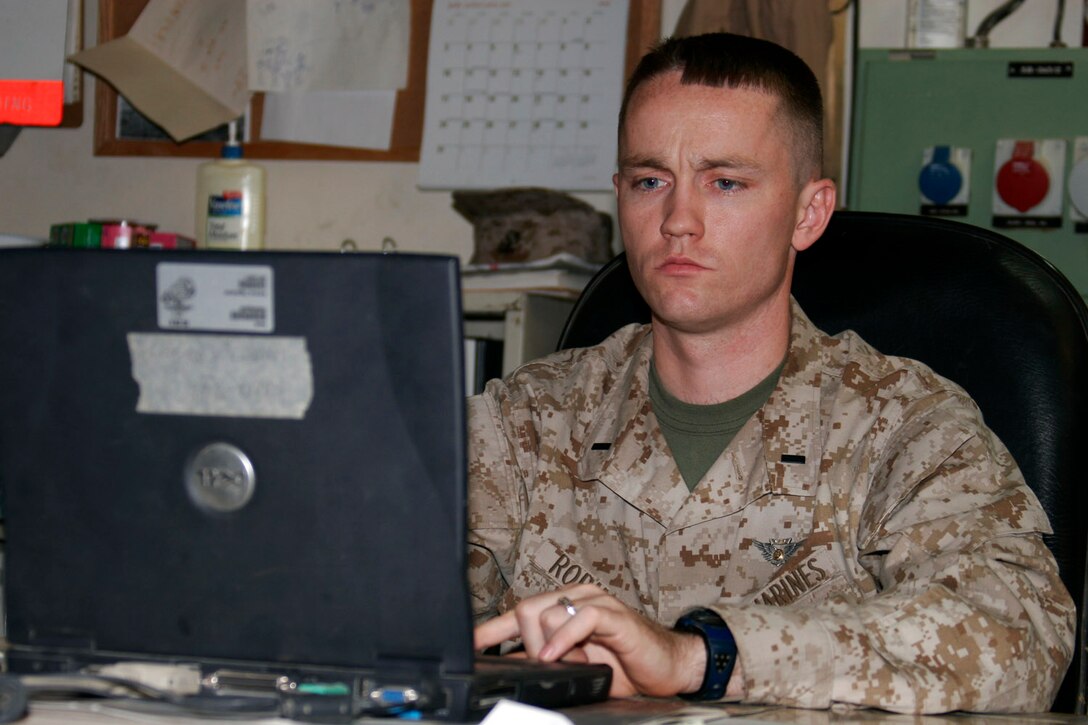 AL ASAD, Iraq ? 1st Lt. Jeremy A. Robinson, maintenance material control officer and aerial observer with Marine Medium Helicopter Squadron 264, manages maintenance records using the Naval Aviation Logistics Command Management Information System on July 3.  A native of New Orleans, Robinson enlisted in the Marine Corps in 1996.  He took advantage of the opportunities service members have to continue their education and received a college degree from Auburn University in August 2001.