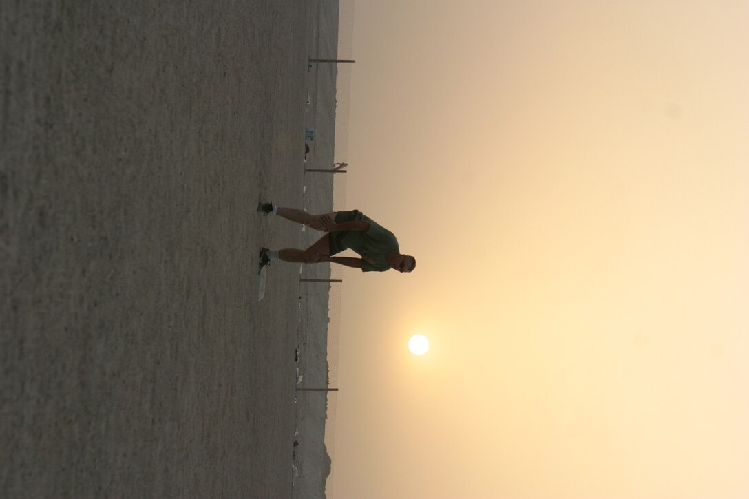 CAMP TAQADDUM, Iraq -- Gunnery Sgt. Thomas Kerschner, camp operations chief with Headquarters and Support Battalion, 2d Force Service Support Group (Forward) stands at second base. The Warrensburg, Ill., native waits for a teammate to hit the ball to advance him around the bases and score a run.