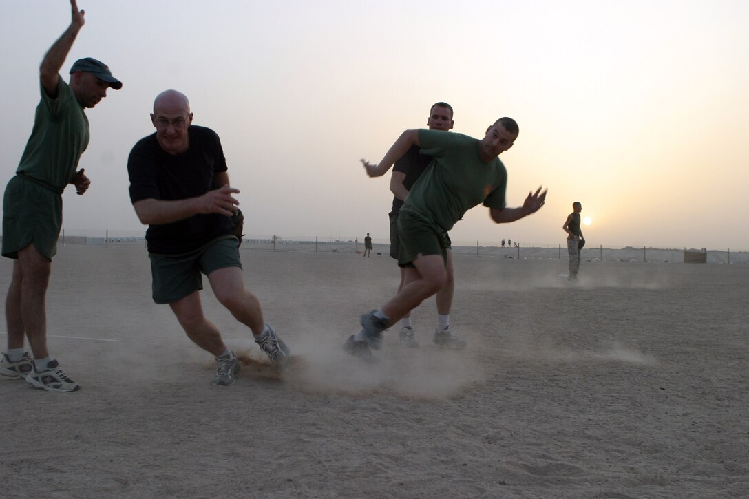 CAMP TAQADDUM, Iraq -- Staff Sgt. James Hull, battalion adjutant chief for Headquarters and Service Battalion, 2d Force Service Support Group (Forward) runs for home plate after the ball is overthrown at third base during a recent softball game.  The Battalion put together a team to play in the Morale, Welfare and Recreation league on base.