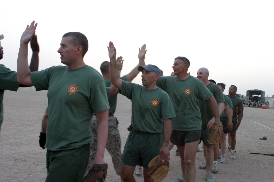 CAMP TAQADDUM, Iraq -- Marines with Headquarters and Service Battalion, 2d Force Service Support Group (Forward) congratulate each other after a recent softball game victory.