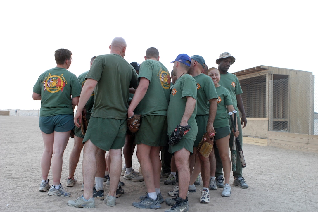 CAMP TAQADDUM, Iraq -- "The Mafia," Headquarters and Service Battalion's softball team, gather around home plate for team meeting after a recent win.  The Marines of 2d Force Service Support Group (Forward) play in a league put together by Morale, Welfare and Recreation.