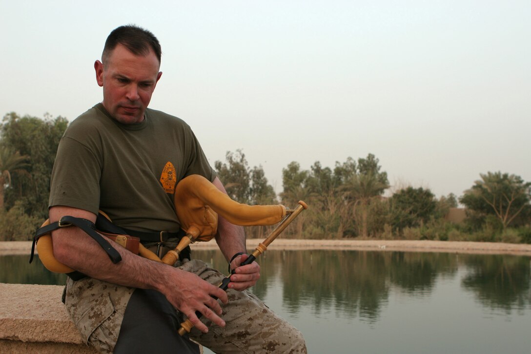 Lt. Col. Patrick J. Carroll, foreign area officer, G-5, II Marine Expeditionary Force, Headquarters Group, II MEF (FWD), plays his Irish Uilleann bagpipes July 2, 2005. Carroll plays his bagpipes in the evenings here.