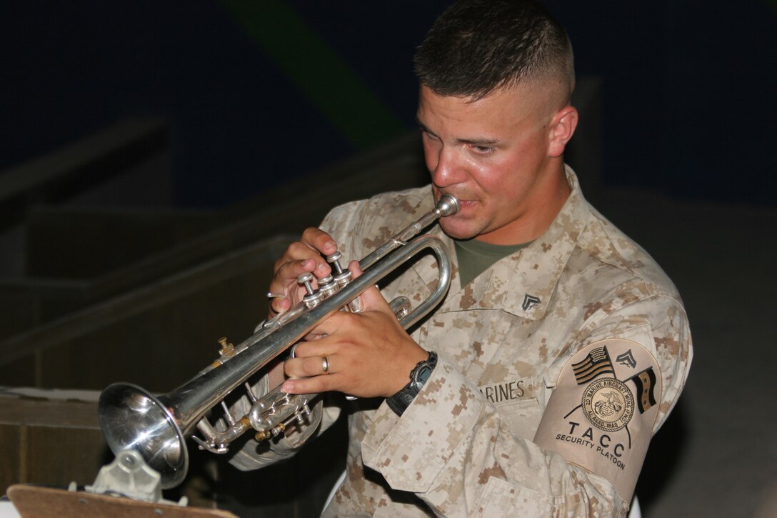 AL ASAD, Iraq ? Corporal Steven Williams, a trumpet player with the forward deployed 2nd Marine Aircraft Wing plays during the Al Asad Independence Day observance here.
