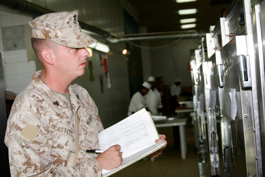 AL ASAD, Iraq ? Corporal Colin B. Castles, food service specialist and Sandown, N.H., native, ensures one of the hot boxes in the dining facility here is set to the right temperature for whenever they start serving meals July 5.  The food service specialists here supervise the work done by contracted civilians and ensure it?s done in accordance with sanitation regulations.