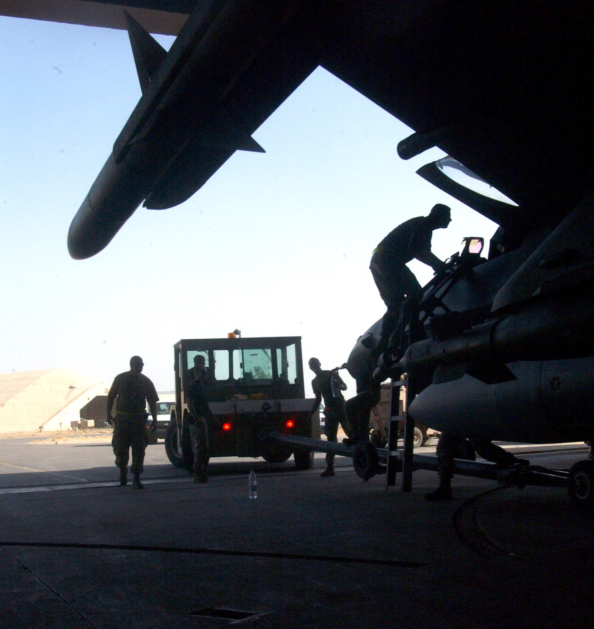BALAD AIR BASE, Iraq -- Airmen with the 332nd Expeditionary Aircraft Maintenance Squadron here prepare to move an F-16 Fighting Falcon in preparation for a mission.  (U.S. Air Force photo by Senior Airman Tim Beckham)                              