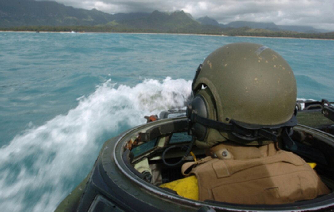 U.S. Marine Corps Lance Cpl. Douglas Young drives an amphibious assault vehicle through the Pacific Ocean towards the beach after departing the amphibious assault ship USS Peleliu (LHA 5) off the coast of Hawaii on June 27, 2005. Marines of the 3rd Amphibious Assault Battalion are going ashore at Marine Corps Training Area Bellows, Hawaii, to conduct infantry and amphibious training. DoD by photo Petty Officer 2nd Class Zack Baddorf, U.S. Navy. 