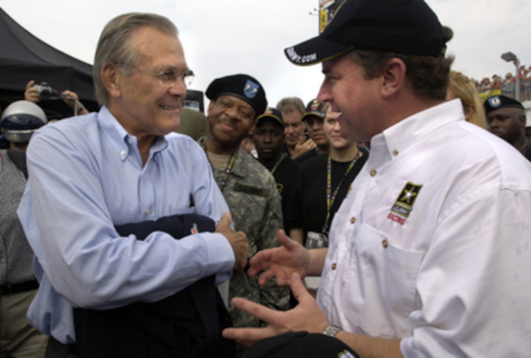 Secretary of Defense Donald H. Rumsfeld speaks with Joe Nemechek, driver of the number 01 U.S. Army Chevrolet, before the start of the Pepsi 400 at Daytona International Speedway, Fla., on July 2, 2005. Rumsfeld met with NASCAR fans, drivers and their pit crews as he toured the infield before the race. Rumsfeld served as the as the Grand Marshal of the 47th running of the Pepsi 400 and gave the command "Gentlemen, start your engines". 